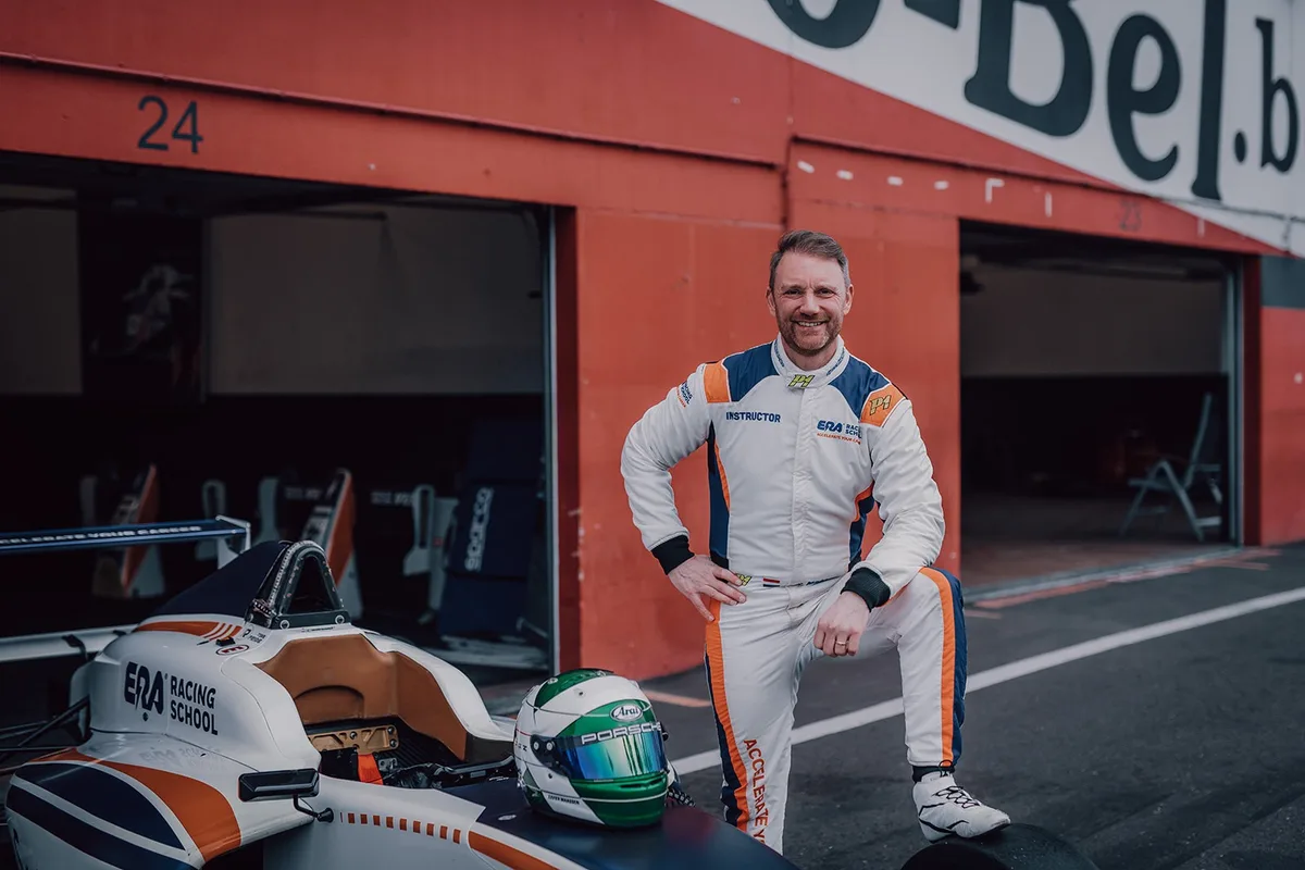 Xavier Maassen, ERA Racing School instructor, beside a formula car